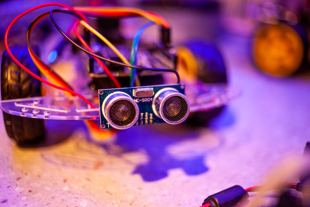 Services Detailed view of a robotic vehicle component showcasing wires and sensors.