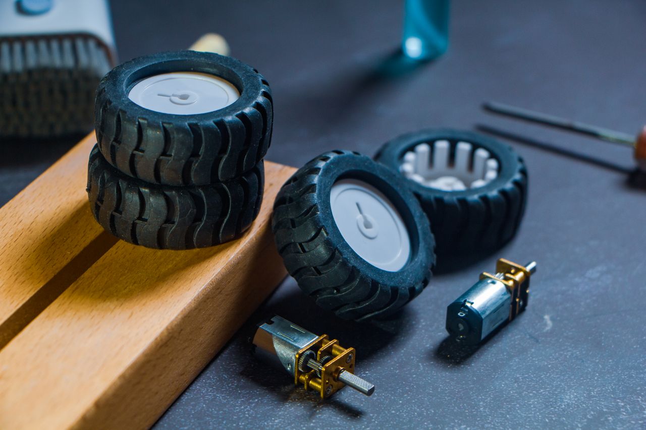 Services Close-up of robotics kit parts including wheels and motors for tech projects.
